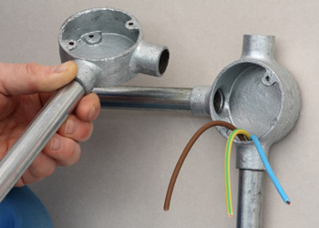 Engineer fixing conduit